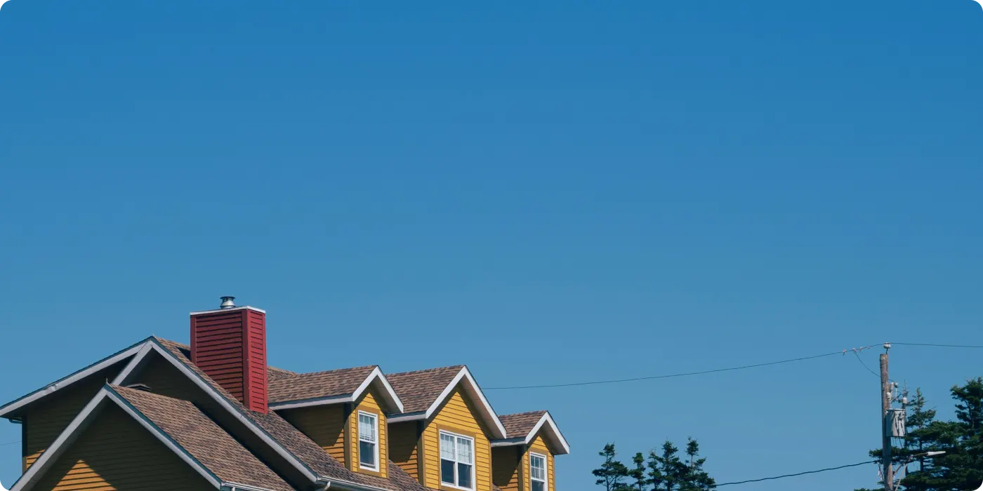 Sunlit homes against a clear blue sky